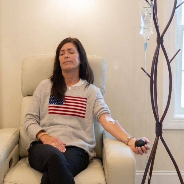 A relaxed woman receiving IV vitamin therapy at Bonfire Wellness.