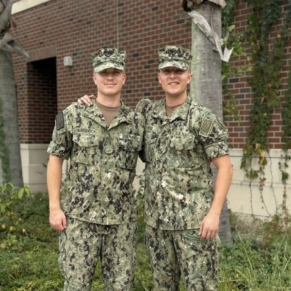 Two U.S. Navy service members in uniform smiling together — Bonfire Wellness military special discounts for active duty and veterans